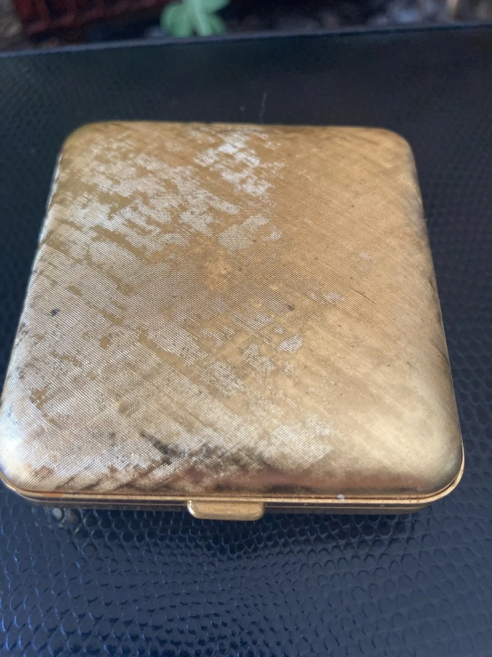 Classic mid-century Seth Thomas folding travel alarm clock in gold-tone texture